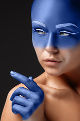 Image showing Portrait of a woman who is posing covered with blue paint