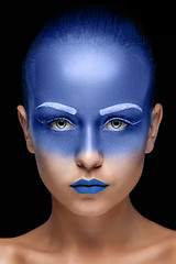 Image showing Portrait of a woman who is posing covered with blue paint