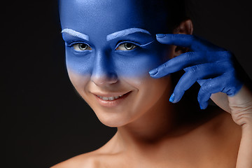 Image showing Portrait of a woman who is posing covered with blue paint