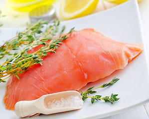 Image showing Raw salmon on the white plate with thyme and salt