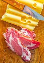 Image showing Bacon with cheese on the wooden board