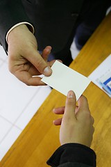 Image showing two hands and a card