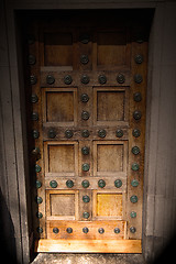 Image showing in london antique brown door  rusty  brass nail and light