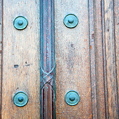 Image showing in london antique brown door  rusty  brass nail and light