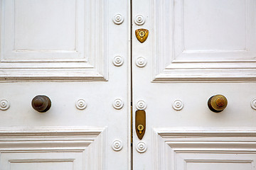 Image showing handle in london antique brown door  rusty  brass nail and light