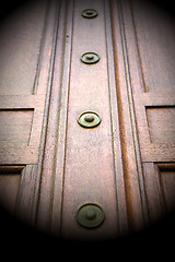 Image showing in london antique brown door  rusty  brass nail and light