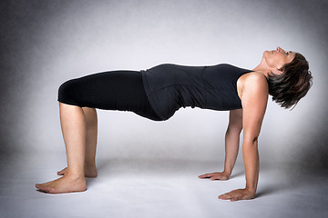 Image showing Middle aged woman back arch