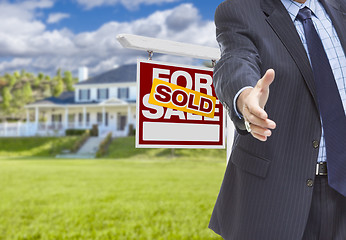 Image showing Agent Reaches for Handshake, Sold Sign and House Behind