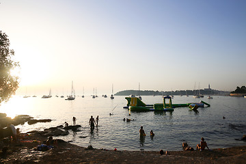 Image showing Tourists sunbathing at sunset