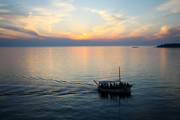 Image showing Boat sailing at sunset