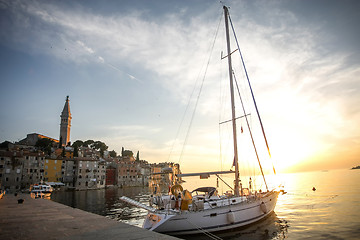 Image showing Anchored sailboat at sunset