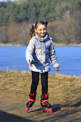 Image showing teenager girl goes in roller skates on the ground