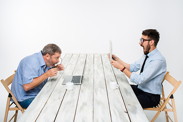 Image showing The two colleagues working together  at office on gray background