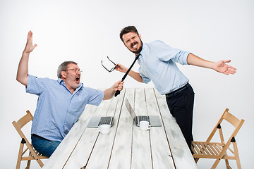 Image showing Business conflict. The two men expressing negativity while one man grabbing the necktie of her opponent