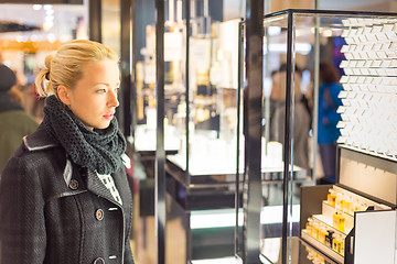 Image showing Beautiful woman standing in front of showcase.