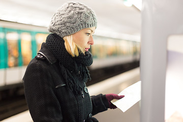 Image showing Lady looking on public transport map panel.