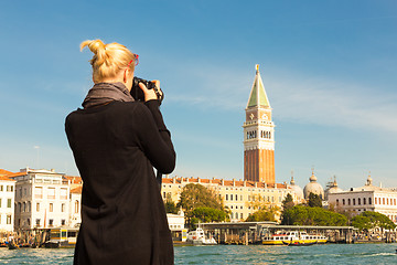 Image showing Female tourist taking photo of Venice.