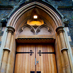 Image showing wooden parliament in london old church door and marble antique  