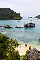 Image showing  boat coastline of a  green lagoon and people