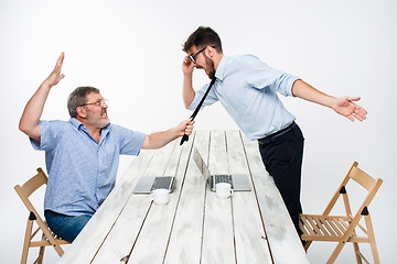 Image showing Business conflict. The two men expressing negativity while one man grabbing the necktie of her opponent