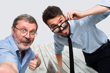 Image showing Two colleagues  taking the picture to them self sitting in  office