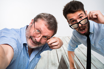 Image showing Two colleagues  taking the picture to them self sitting in  office