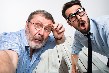 Image showing Two colleagues  taking the picture to them self sitting in office