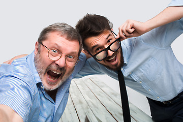 Image showing Two colleagues  taking the picture to them self sitting in  office