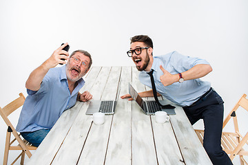 Image showing Two colleagues  taking the picture to them self sitting in office