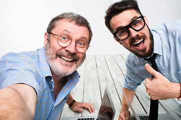 Image showing Two colleagues  taking the picture to them self sitting in  office