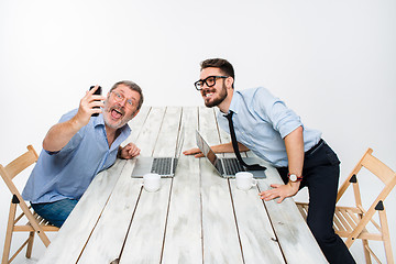 Image showing Two colleagues  taking the picture to them self sitting in office