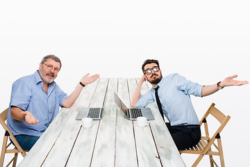 Image showing The two colleagues working together at office on white background