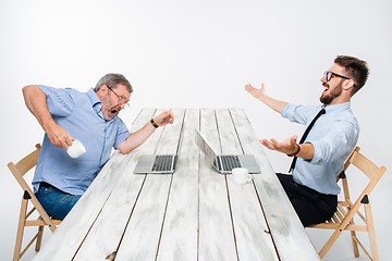 Image showing The two colleagues working together at office on white background