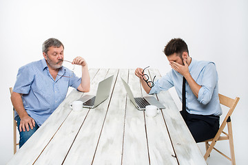 Image showing The two colleagues working together at office on white background