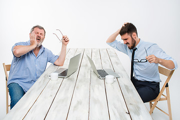 Image showing The two colleagues working together at office on white background