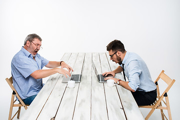 Image showing The two colleagues working together at office on white background