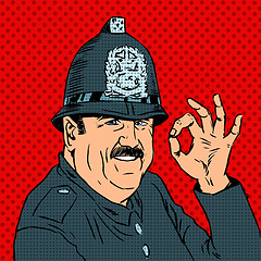 Image showing English policeman in uniform and helmet shows gesture OK
