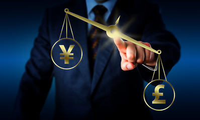 Image showing Pound Sterling Outweighing The Yuan On A Balance