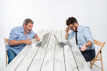 Image showing The two colleagues working together at office on white background