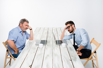 Image showing The two colleagues working together at office on white background