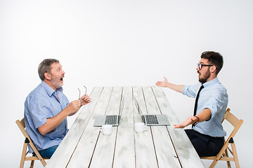 Image showing The two colleagues working together at office on white background