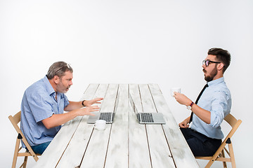 Image showing The two colleagues working together at office on white background