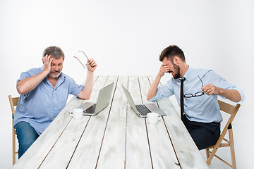 Image showing The two colleagues working together at office on white background