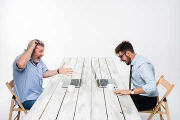 Image showing The two colleagues working together at office on white background