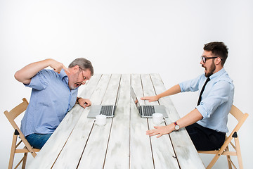 Image showing The two colleagues working together at office on white background