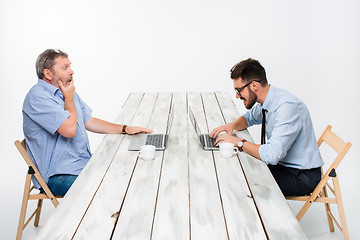 Image showing The two colleagues working together at office on white background