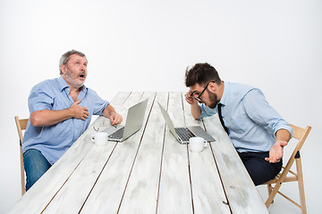 Image showing The two colleagues working together at office on white background