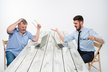 Image showing The two colleagues working together at office on white background