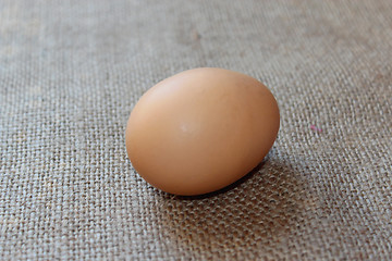 Image showing an egg of hen on the sacking background