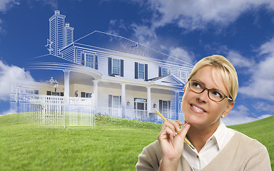 Image showing Smiling Woman Holding Pencil Looking to Ghosted House Drawing Be